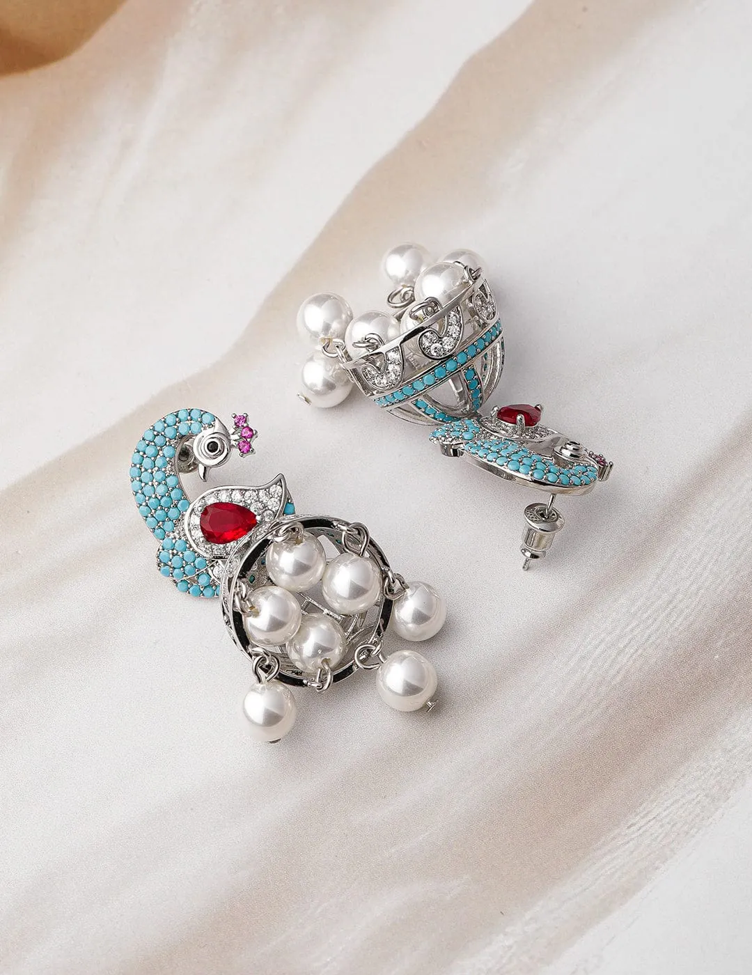 Rhodium-Plated Turquoise Blue & Ruby AD & Zirconia Studded Peacock Design Jhumka Earrings